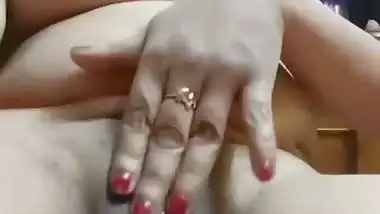 Chubby, young lady enjoys fingering her shaved pussy